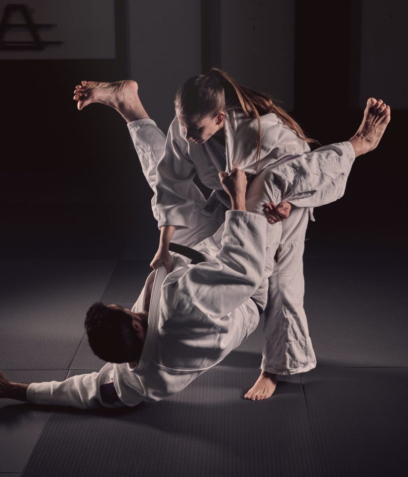 Woman practicing martial arts with man